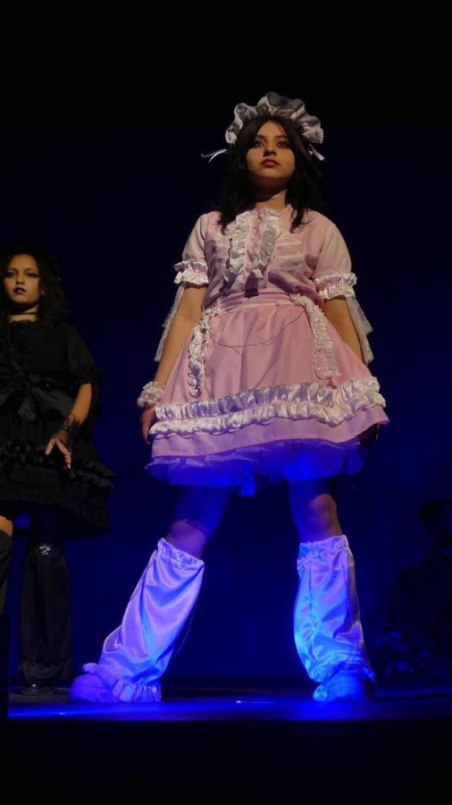 A SHADOW OF PERSONAL STYLE: Designs by junior Isa Pirkey make their runway debut during the Saturday fashion show, styling freshman model Marveyah Munoz-Tavera. Inspired by the “reflections and shadows” theme, Pirkey designed two dresses that were shadow versions of one another. Similar in silhouette, one dress was pink with white detailing and the other was entirely black. 

Ive always been really inspired and interested in EGL fashion, which is a genre of Japanese fashion, and Ive always wanted to make my own,” Pirkey said. 

When Pirkey heard that the theme of the 2023 fashion show was “reflections and shadows,” so was so inspired that she pushed her worries aside and decided to participate in a McCallum fashion show for the first time.

“Im a big fan of contrast, and so the ‘shadows’ theme was really inspiring to me,” Pirkey said. “Ive always wanted to get more into designing my own clothes. I like wearing fun things just usually dont have a lot of time.”

After months of work, Pirkey was both surprised and proud to find out on Sunday that she had tied for second place. She hopes to do the fashion show again next year, especially after she learned a valuable lesson.

“I learned that I should not cram sewing because my sewing machine might break,” Pirkey said. “If I have time I would love to keep designing, and I think that once I get over being so tired from all of this, Im definitely going want to do it next year.

Caption by Ingrid Smith. Photo by Julia Copas.