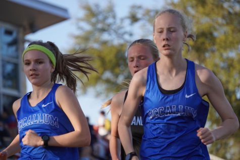 Junior Josie Blackwell and sophomore Lillian Gray run in the two-mile race at the St. Andrews invitational. 