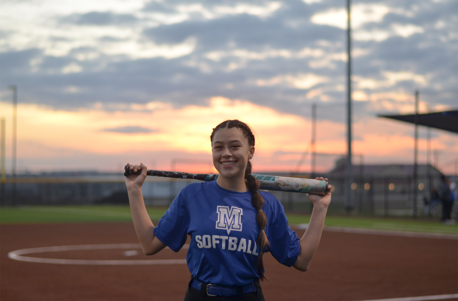 Senior+softball+captain+Ary+Sanchez+poses+with+her+bat+out+on+the+field+at+Feb.+6+scrimmage+against+Manor+Tech.+Sanchezs+love+for+the+sport+started+when+she+was+young%2C+growing+up+in+a+family+of+softball+and+baseball+fanatics+and+joining+her+first+team+at+age+5.+Now%2C+she+leads+the+varsity+Knights+and+represents+the+school+decked+out+in+a+white+and+blue+uniform.
