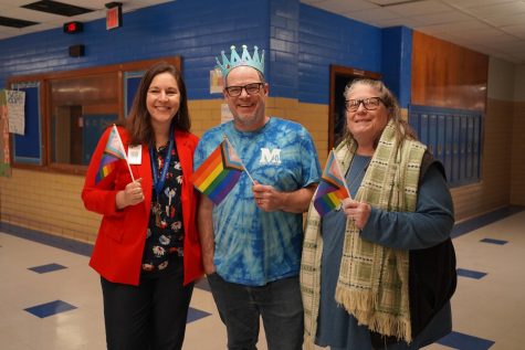 PART OF HISTORY: Principal Nicole Griffith, journalism teacher Dave Winter and science teacher Elaine Bohls-Graham pose with pride flags on the first day of AISD PRIDE Week. At his previous school in Midtown, Atlanta, Winter witnessed a similarly accepting and robust observance of PRIDE week. However, he feels that McCallum's history and culture, particularly with Spectrum, make Mac's PRIDE celebrations unique. 

"For as long as I have been at Mac and before that, [Spectrum] has been vital in providing a safe space for LGBTQ students to be themselves," Winter said. "The group has had a lot of turnover with faculty sponsorship in recent years, but its essential role has stayed constant through all of that. I think that the main thing is that Spectrum and PRIDE Week helps to give students a voice on campus." 

PRIDE Week closely followed Black History Month, where students and faculty organized similar events, like student panels. In both instances, Winter saw how crucial and courageous it is for students to lead the conversations on issues like identity. 

"I was impressed [by] the fearlessness and leadership of the panelists and the willingness of students and teachers to listen and work to understand better the experience of others," Winter said. 

Caption by Francie Wilhelm. Photo by Lillian Gray. 