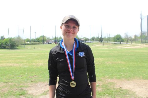Sophomore Callen Romell poses with her district team championship medal. Romell also placed second individually
at the 5A district
meet.