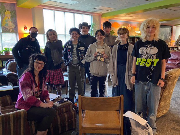 The Banned Book Club takes a moment during a its  weekly FIT meeting on March 21 to pose for a group photo in the library. The club discussed the first section of “The Poet X” which was selected by Black Pearl Books for banned book clubs across AISD. 