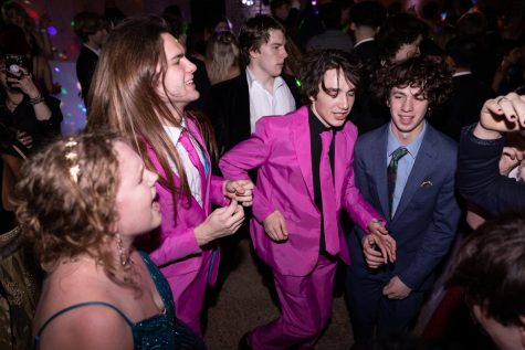 PINK FOR PROM: Seniors Vaughn Vandegrift, Peter Wiseman, Max Yehaskel and Alex Gold sing and dance their hearts out at Saturday’s “Under the Knight Sky” prom. Yehaskel and Wiseman stood out in the sea of black and navy suits as the pair opted for bright pink with contrasting, yet coordinating, shirts and ties. While the style decision seemed big to onlookers, for Yehaskel it was a simple choice.

“I like pink, it’s a solid color,” he said. “It almost melted when I ironed it actually. It’s 100% polyester, and I got it from Kohl’s.”

Yehaskel enjoyed prom overall, except when it came to the royalty announcement.

“Someone stole prom queen from me,” he joked. “It was very tragic. But other than that, it was fun.”

As prom marks another milestone at the end of senior year, Yehaskel is ready to sit back, relax and enjoy his last few weeks as a Knight.

“My grades don’t matter anymore [and] after AP tests I’m done,” Yehaskel said. “I’m going to go nuts, and I’m going to start cooking more.”

Caption by Francie Wilhelm.