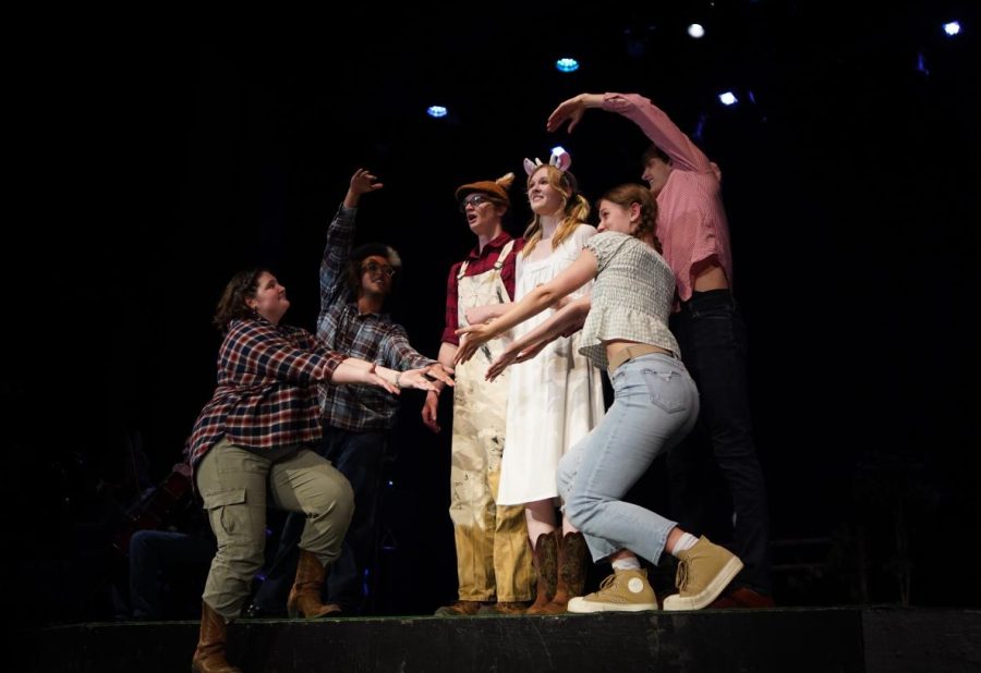 MAKING MOO-VES IN THE ENSEMBLE: Sophomores Zoe Maxwell and Robin Kulhanek, senior Atticus Adair, juniors Addie Knight and Henry Mayes and sophomore Zalie Mann perform "Notice Me" on the opening night of Cows: the Moosical.

Maxwell, who was a member of the three-person ensemble, found dancing on Cows to be an especially intimate experience compared to their past experiences with MacTheater.

“I had worked with everyone in the cast before, and it was really refreshing to have fun with something that was so homemade,” Maxwell said.

Not only was Cows a smaller-scale production but also a faster-paced one. According to Maxwell, rehearsals were hectic but still fun.

“There were probably only a few rehearsals where everybody in the cast was there,” Maxwell said. “[Mann] and I spent the week before and of the show running back and forth between Cows rehearsal and Mac Dance rehearsals. It was very much ‘down to the last minute’ kind of rehearsal, but once the adrenaline kicked in, everything came together.”

During this frenzied pre-show period, Maxwell worked closely with director, choreographer and writer senior Anderson Zoll to perfect her performances of the many dance numbers throughout the show.

“I had some prior experience working with Anderson as the choreographer for both Pippin and Descendants, but it was really incredible seeing him work not just for choreo, but writing, staging and managing all together,” Maxwell said. “I think he’s a great choreographer, and he’s super open to suggestions and collaboration.”

Once the lights were on and the stage was set, Maxwell saw the fruits of their, and the rest of cast and crew’s, labor reflected in the audience’s reactions.

“[I loved] watching the cast from the sides and hearing the crowd laugh at all the parts I love in the show,” Maxwell said. “I think also getting to perform in the FABT for the first time was a great experience.”

Caption by Francie Wilhelm. 