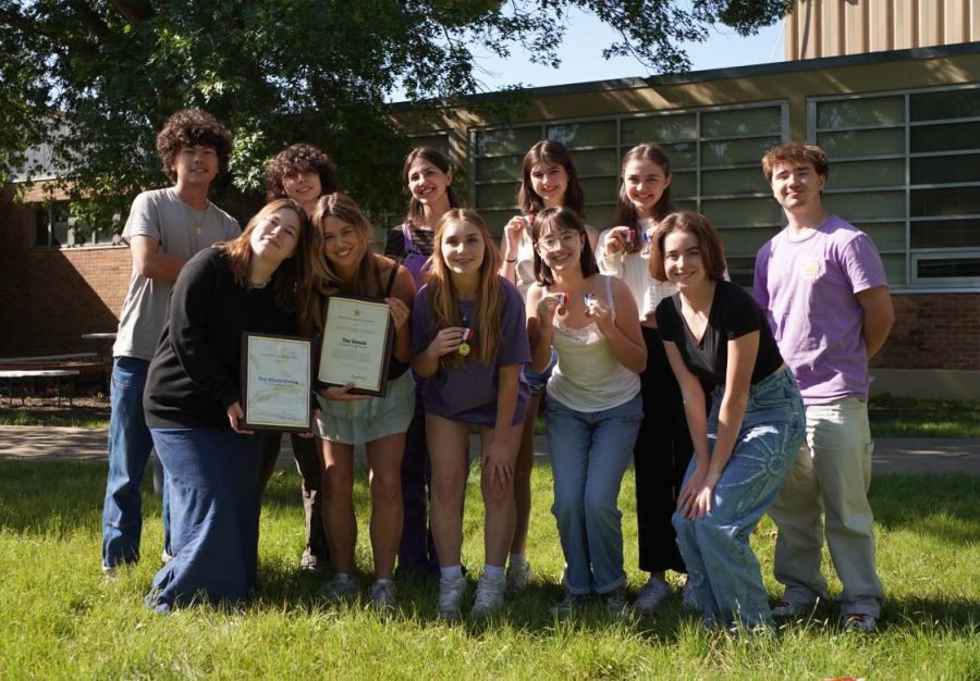 The first-period Shield class poses for a photo with its Interscholastic League Press Conference Gold Star Awards for print and online newspaper and some of its 15 Tops in Texas individual achievement award medals earned at the 2023 ILPC Spring Convention.
