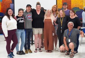 The English department surrounds retiring department chair Diana Adamson as she wraps up her 22nd and final year at McCallum at todays end-of-year Maculty luncheon.
