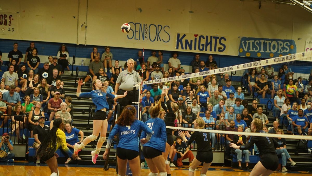 GAME GETS INTENSE: The crowd watches intently as junior co-captain Greta Carlson rears up for a spike during the third set of an intense varsity matchup with Ann Richards last Friday evening. Despite displaying an impressive level of prowess befitting of her position, Carlson and her comrades ultimately took home the first district loss for the varsity girls volleyball team since 2021, Despite the defeat, she is confident that with better coordination, future success is all but assured. 
“I think we’re fully capable of beating Ann Richards,” Carlson said. “I think that Friday was just an off night for everybody.”
Caption by Noah Braun. 