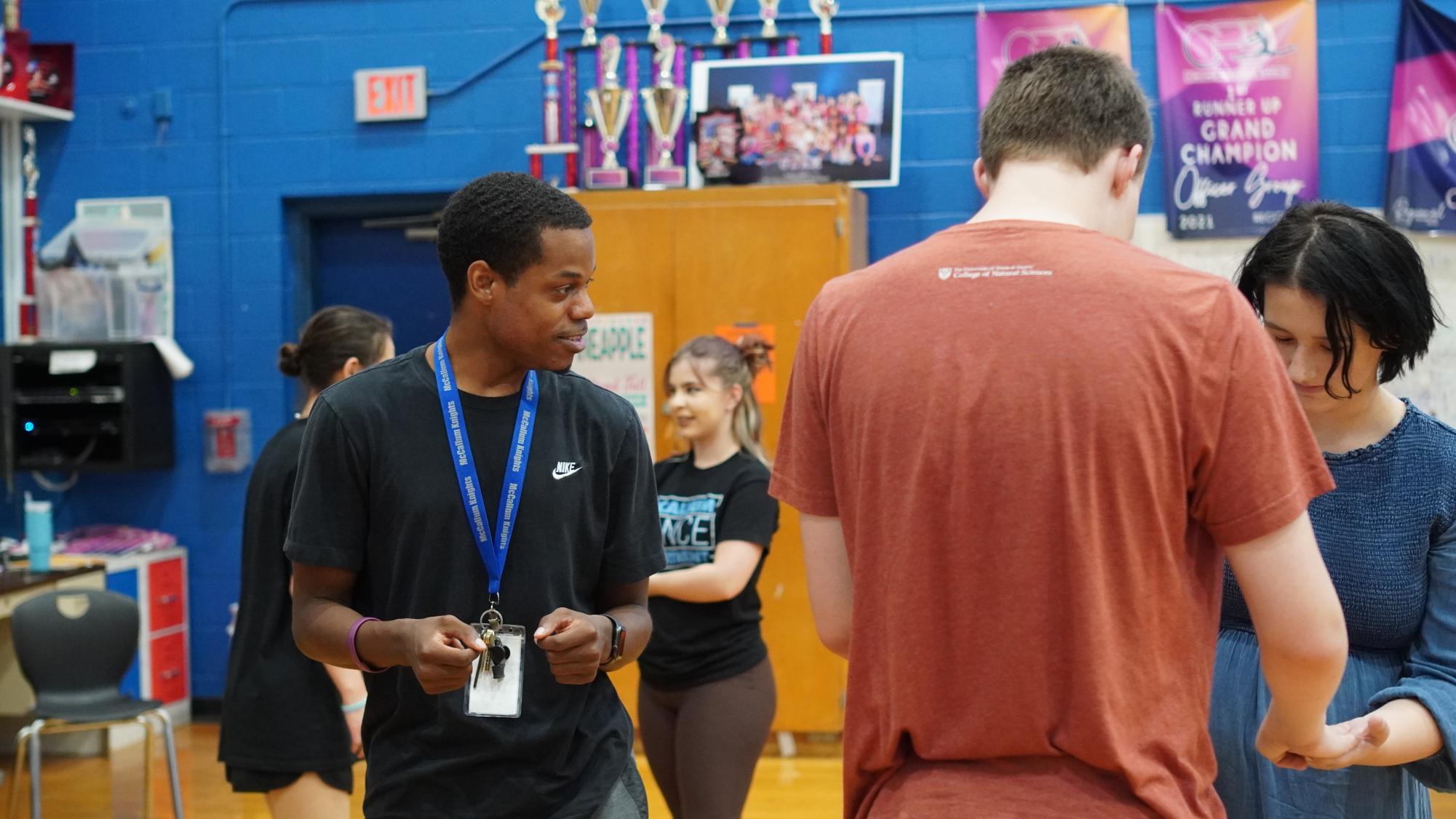 LENDING A HELPING HAND: Carson aids his Dance I students in their cultural dance unit of salsa, flamenco and other unique styles. For Carson getting involved with all his students dance careers makes his job worthwhile. Getting people to trust each other, getting kids to realize what their potential is, Carson said. Its helped me a lot, just as an instructor and an educator all around. 