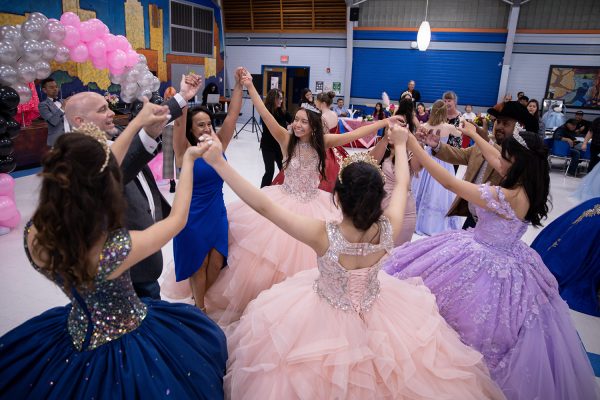 SCOTTS FREE: At the Fourth Annual McCallum Quinceañera on Saturday in the cafeteria, freshman Adrina Scott dances with her family and friends. “At quinceañeras they have a dance for you with your dad, and then a dance for you and your mom,” Scott said. With two daughters participating, Scott’s parents had to figure out how to split their time between their daughters. “My friend’s parents also have two girls,” Scott said. “Obviously you can’t dance with your dad at the same time as your sister. So, we all kind of just got together and all danced together.” For Scott, the quinceañera was a result of lots of preparation at hard work. “There was a lot of practice that we had to do during lunches and during fit,” Scott said. “Sometimes that would get a little stressful because you know, it’s lunch. You kind of want to hand with friends, but I think it all worked out really well.” Part of the preparations that Scott loved was getting to try on the dresses. “Basically all the dresses that we had were rentals,” Scott said. “We had to go try on the dresses, and it was fun to have that experience to go get the dress and try it on. You just felt so special.” The McCallum Quinceañera is an important memory of Scott’s life. “I think it’s just such a fun tradition in the Hispanic culture,” Scott said. “I got to dance with my family which was special.” Caption by Kate Boyle.