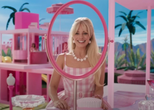 Stereotypical Barbie played by actress Margot Robbie looks at herself in a toy "mirror". The fact that there was no reflection is one of the ways director Greta Gerwig used the aspects of the toys in the film. Warner Bros. image reposted here under the doctrine of fair use.