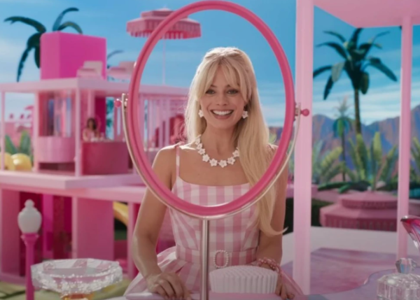 Stereotypical Barbie played by actress Margot Robbie looks at herself in a toy mirror. The fact that there was no reflection is one of the ways director Greta Gerwig used the aspects of the toys in the film. Warner Bros. image reposted here under the doctrine of fair use.
