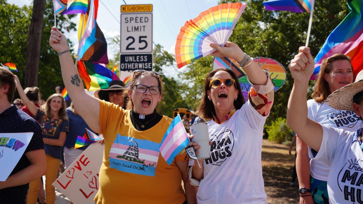 Parents support their children with a pride rally.