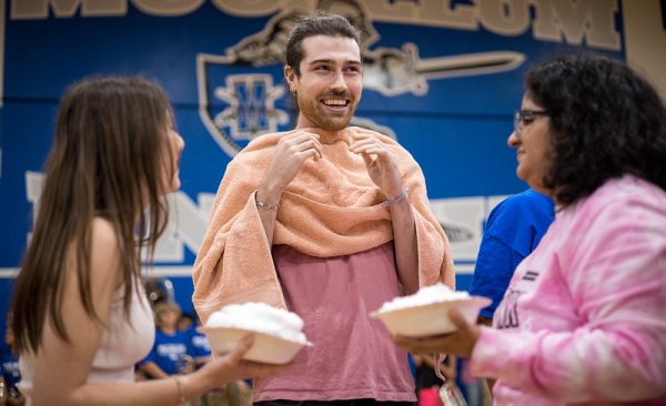 Jace Klein prepares to be pied by PALS Hana Diamond and Ariana Mendez at the 2022 Pink Week pep rally.