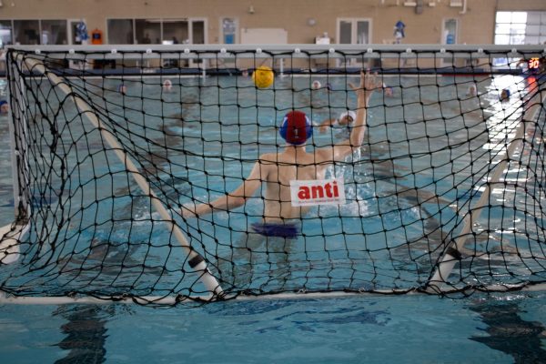 Junior Theo Northcutt blocks the ball at first water polo tournament of the season in Round Rock on Sept. 15. 