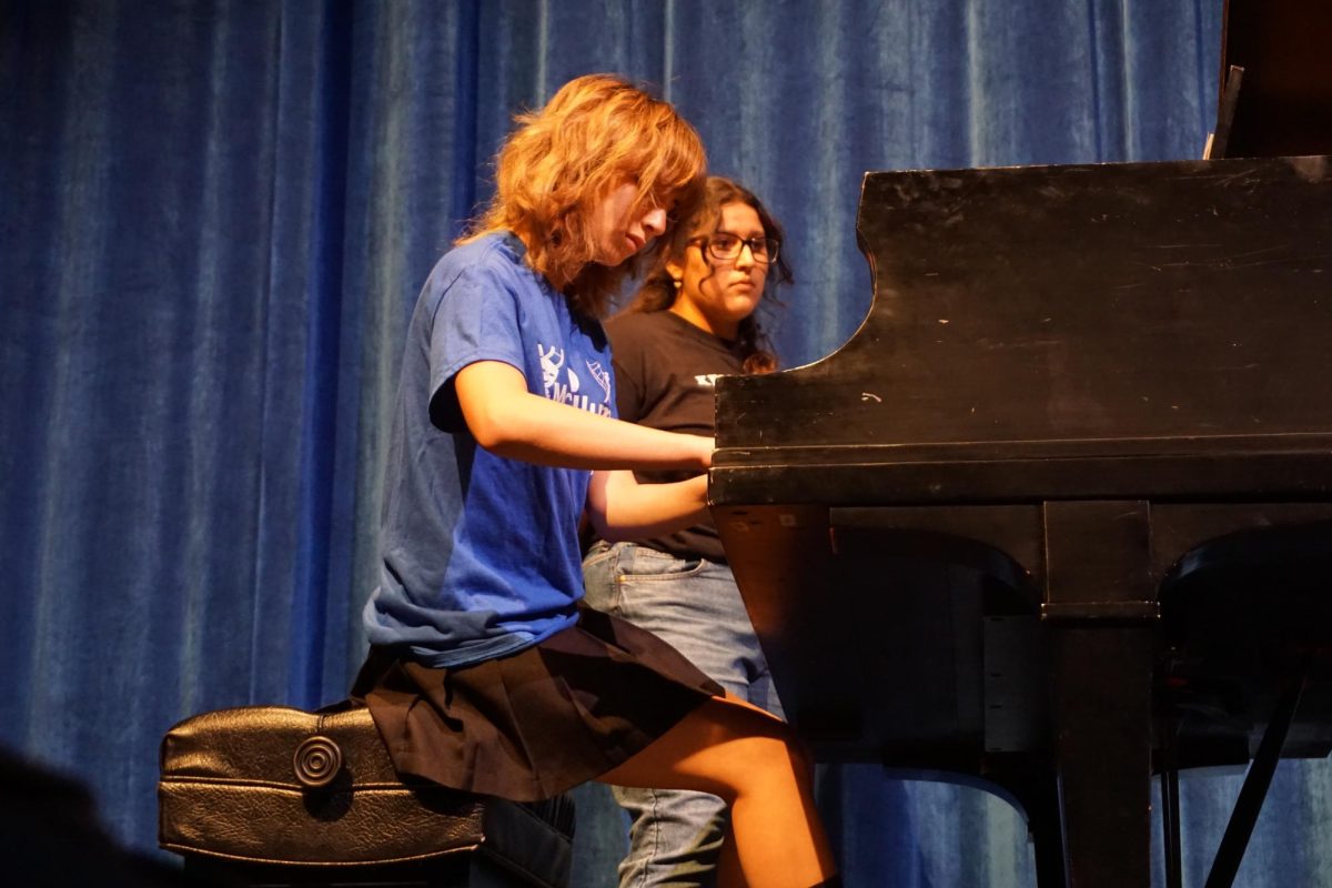 (insert name) playing a piano piece during the Fine Arts Showcase. 