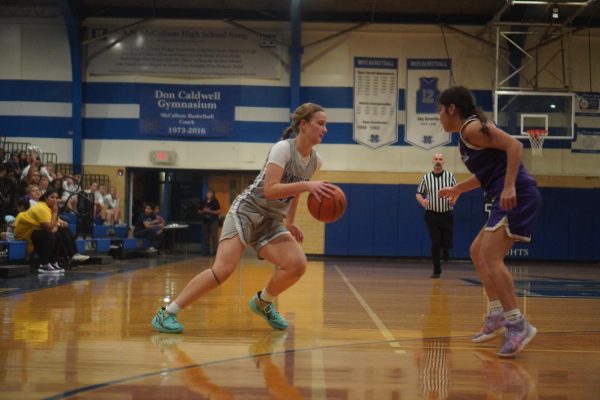 Ella Burns squares up against a Marble Falls defender and gets ready to dribble into the paint.