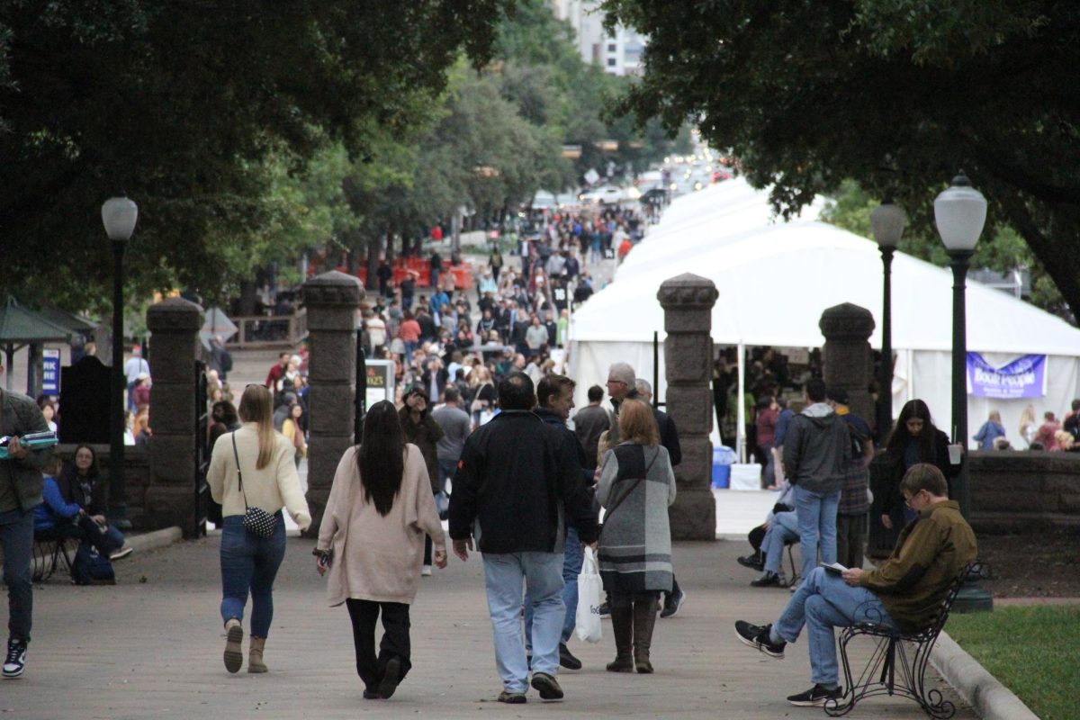 Crowds walk on the Texas State Capital Lawn towards the Texas Book Festival.