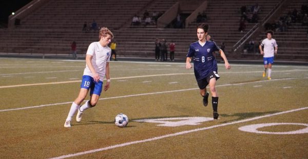 Junior Evan Burnside keeps the ball away from a Raptor during Friday nights game. 