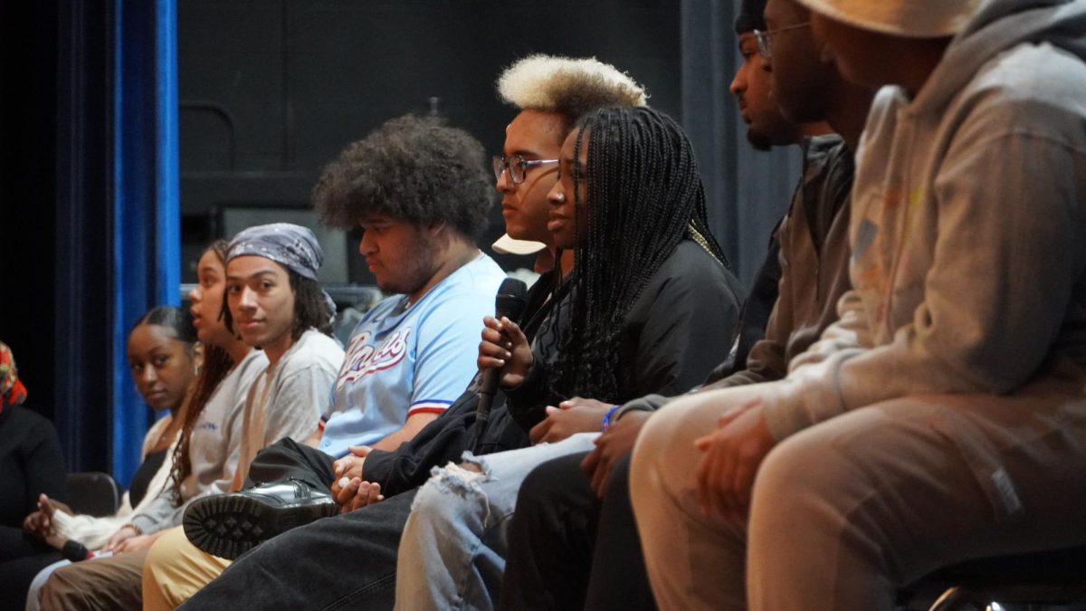 Freshman Paityn Jones speaks as part of the panel during the Black History Month assembly during fifth period. Jones said that being a member of the Knights Steppers and having Black teachers have given her spaces where she can be herself. 