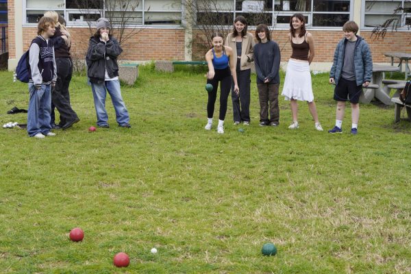 Sophomore Corinne Hampton, with her eyes closed, rolls her bocce ball during the third round of the Niche Sports bocce ball game.