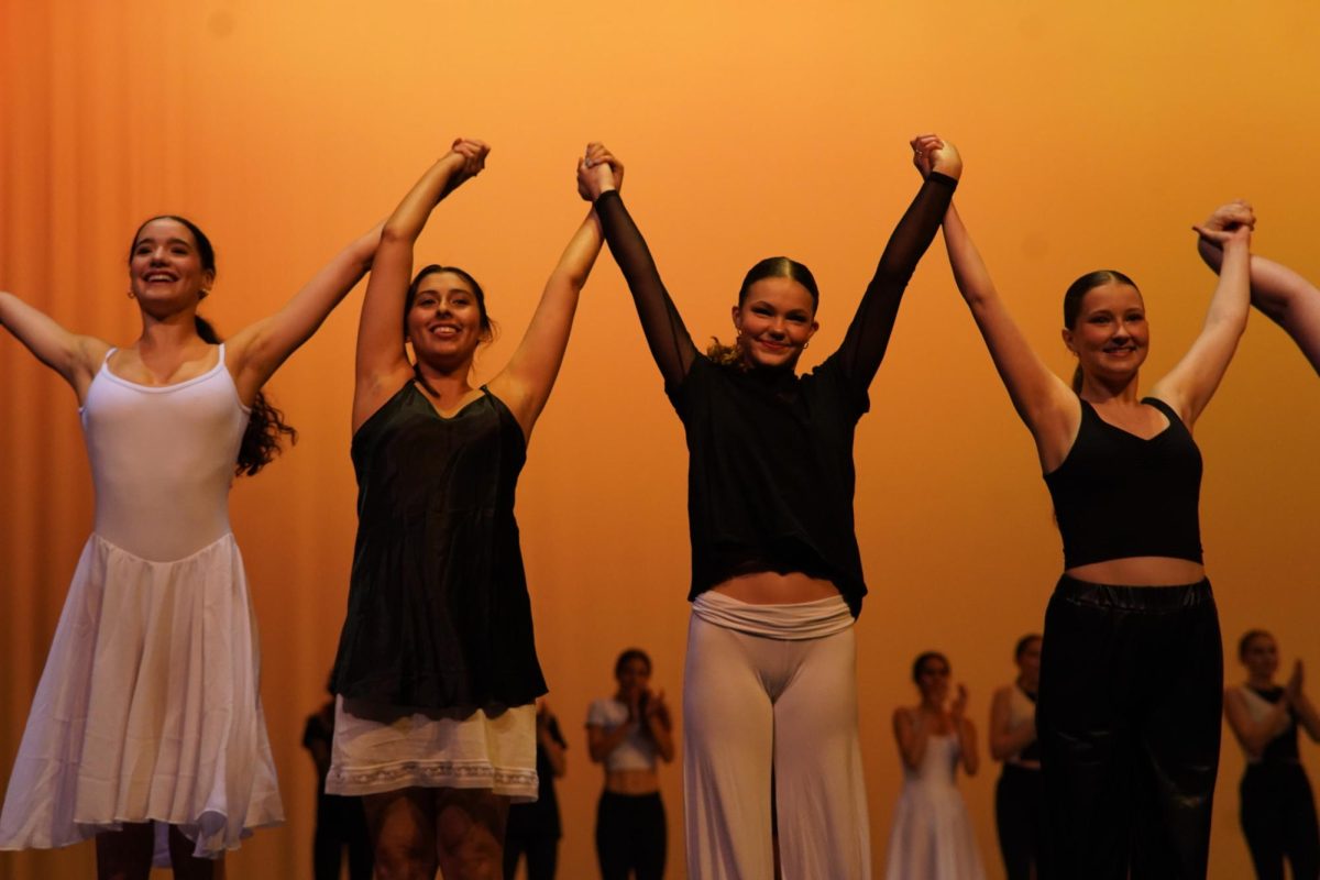 Sophomore Perla Vela, Gaby Alvarado, Maya Wallace, and Catherine Haikola bowing during the 2023 McCallum Youth Dance Company spring show. 