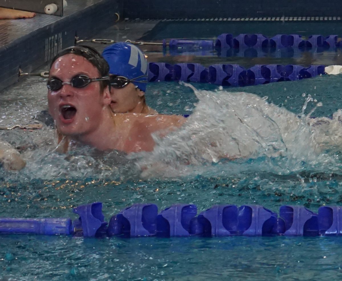 Matthew Cagle reaches the wall in his 400 yard freestyle relay at a McCallum tri-meet against Ann Richards. 