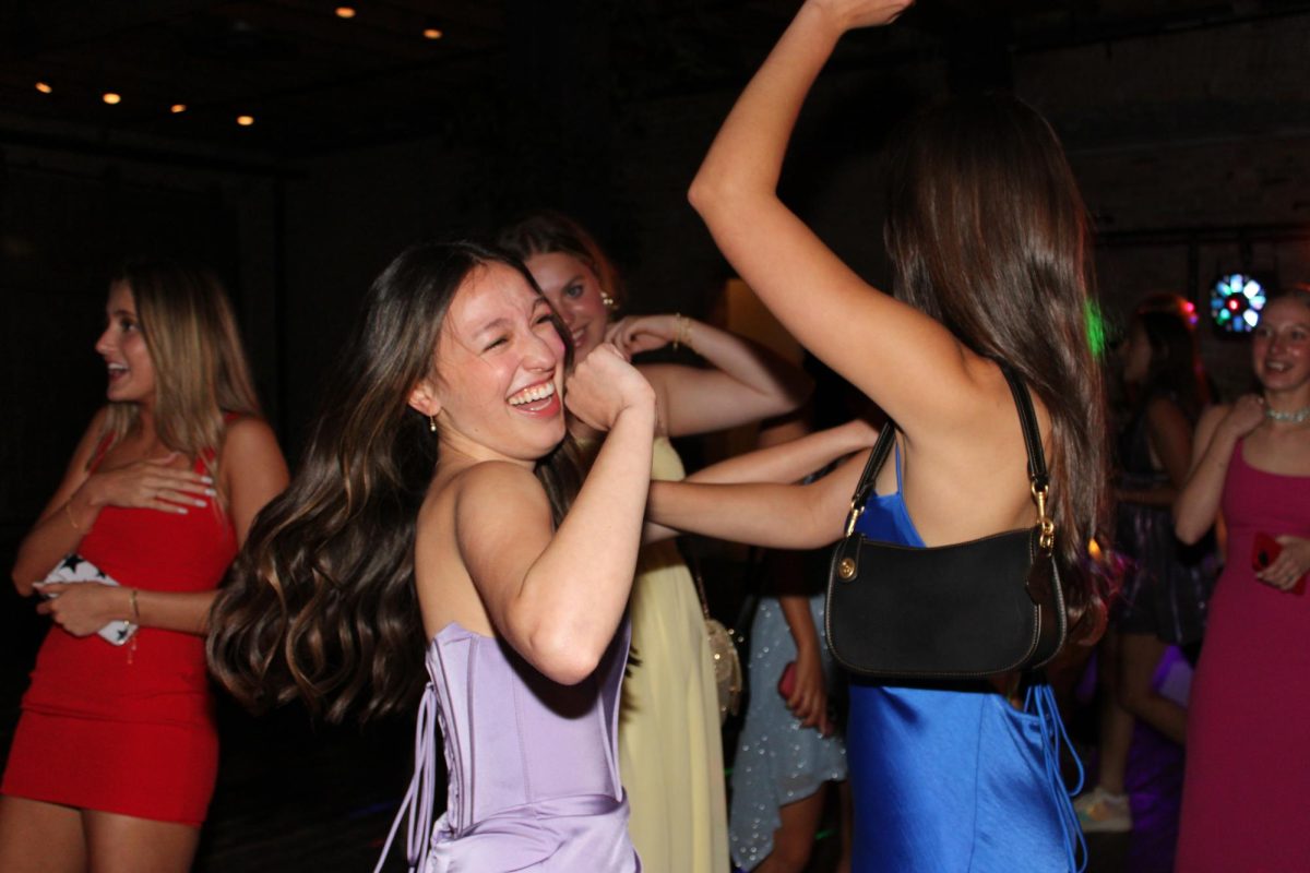 BESTIES TAKE ON PROM: Senior Bella Gonzales dances with junior Helen Rodgers during prom last weekend. 

“At dinner before I told my friends they better dance with me and they told me ‘no,’” Gonzales said. “But Helen said, ‘Of course I’ll dance with you,’ so Helen was the first friend that started dancing.” 

Instead of taking a traditional date, Gonzales invited various junior friends to join her at prom. 

“Instead of having a guy date, I invited a bunch of my junior friends,” she said. “I actually am so happy with that decision because it was just so fun having all my girls with me.” 

While the day of prom provided many fun events besides just the dance, Gonzales still enjoyed the dance itself the most. 

“The whole day of prom there are so many fun things to do,” Gonzales said. “We made bouquets together and got ready, but I was most excited to be at prom and see everyone I knew, and to see everyone dressed up.” 

Gonzales especially appreciated the vibe stablished at prom. 

“It was such a positive environment where everyone was hyping each other up, and we were all so high energy,” Gonzales said. “Its just such a positive environment at prom where everyone is so happy and having a good time.” 

Besides the welcoming atmosphere, Gonzales especially looked forward to the dancing.

“My friend Ellie and I were getting into the song ‘Beauty and the Beat’ together, and also ‘Cupid Shuffle,” she said. “They are just such classics.” 

When looking back on the dance and her senior year as a whole, Gonzales says she will forever remember how kind the class of 2024 is. 

“I will always remember how close and how kind every single person in our class is,” Gonzales said. “I feel like we have no mean girls, no enemies, and we all love each other and love being together.”

Caption by Naomi Di-Capua. 