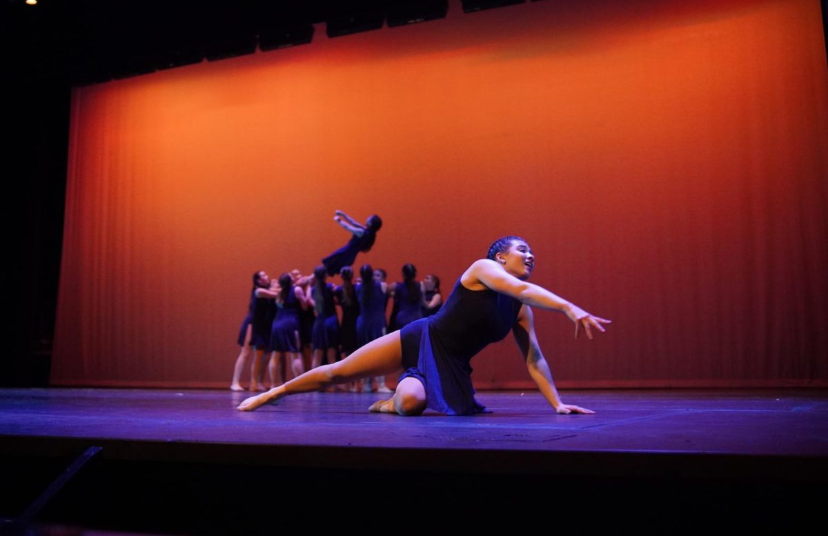 A TURNING POINT IN BB SEASON: While Blue Brigade typically focuses on the spirited pom routines and kick lines at football games, according to sophomore Chloe Seckar-Martinez, the team’s Spring Show provides a unique opportunity for them to tune into a different style of dance. Seckar-Martinez takes the stage during the team’s contemporary dance “Turning Tables.”

The dance, since it differed from normal Blue Brigade style, was especially rewarding to perform and see succeed according to Seckar-Martinez. 

“It’s like one of our only dances where we’re really more into the emotional side of it,” Seckar-Martinez said. “It was almost our first run to be able to just see how much our hard work had paid off.”

For Seckar-Martinez, the dance was especially unique because it was the second to last time she would be performing with seniors, and that moment would be memorable. 

“It was meaningful because our seniors were able to have this show without feeling really sad,” Seckar-Martinez said. “This was our chance to do it [perform] with not as necessarily high of emotions since we didn’t know we were going to be able to dance it again.” 

The contemporary dance was choreographed by assistant director Jamie Friedman. Her addition to the team was new this year, so the dance provided a special element for Blue Brigade in knowing how much she worked at improving the team, according to Seckar-Martinez. 

“This was the first dance that we ever got choreographed by our assistant director for the first time, so that was really special,” Seckar-Martinez said. “To be able to do one of her pieces, especially at the show, since this is her first year was something very meaningful.

Seckar-Martinez said the dance created an emotional connection amongst those who performed it, given the emotions that came with it, and the amount of work that went into perfecting it for the stage.

“It was a very meaningful dance, and It was our chance to just have a lot of fun with it and just see what we can show the audience for the first time,” Seckar-Martinez said. “It may be something that no one’s heard of, or that no one’s seen.” 

Caption by Chloe Lewcock. 
