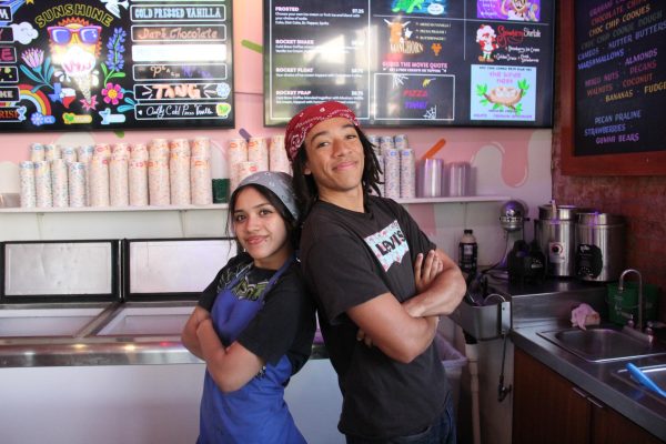 Seniors Jude Masoni and Lainil Ortiz pose behind the counter of Amys Ice Creams on Burnet Rd. where they are working a Friday evening shift.