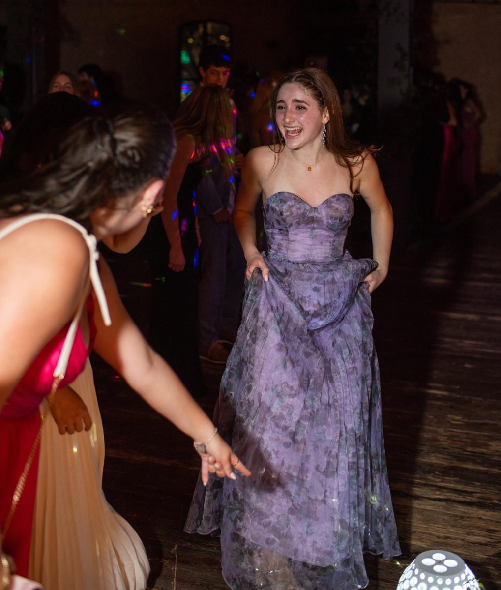 BOPPING TO THE BEAT: Senior El McGinnis dances with senior Olivia Hexsel at Brazos Hall during prom night. For McGinnis, the best part of the experience was seeing the senior class come together for a shared evening of fun.

“It was awesome,” McGinnis said. “Everyone was dancing the whole time, which made it even better. Everyone [was] having a good time.”

McGinnis also enjoyed seeing Hexsel and senior Luca Leone be honored as prom royalty after weeks of voting by the senior class.

“[My favorite part was] watching my friends win prom king and queen,” McGinnis said.

Despite the fun-filled activities of the night, McGinnis felt prom was slightly bittersweet, serving as a marker of the end of her time in high school.

“I am so excited to graduate and experience a whole different environment surrounded by people who share the same passion as me,” McGinnis said. “But I will miss seeing my friends every day.”

Caption by Alice Scott. 