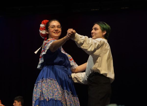 MESMERIZING MAZATLAN: Sophomore Mailyn Gil and senior Keegan Sarwate dance the Mazatlan together during the Cinco De Mayo show on May 3, put on by Ballet Folklorico. The Mazatlan dance comes from the region of Sinaloa. 

During the show, various dances, songs, and beats were performed to celebrate Cinco De Mayo, which celebrates the Mexican victory over France on May 5, 1862.

This is Gil’s second year being part of Ballet Folklorico time and second year being a part of the Cinco De Mayo show. With Juana Gun, the former sponsor of Ballet Folklorico, leaving and Telvi Altamirano-Cancino taking over as the new sponsor, new performances were introduced into this years Cinco De Mayo show. 

One of which was the introduction of the steel drums. Watching the steel drums performance was Gil’s favorite part of this year’s show. 

“All of the club members were dancing and having fun backstage,” she said. 

As well as watching the drum performance, performing the Torito was Gil’s favorite part because of the costume elements.

“Women wore the traditional Chiapas dress which has colorful flowers embroidered in it,” Gil said. “The men wear Torito masks which are handmade masks that look like bulls.”

Ballet Folklorico has been practicing traditional dances for multiple weeks leading up to the big performance and also has spent time making various parts of costumes. 

Caption by Maya Tackett. 