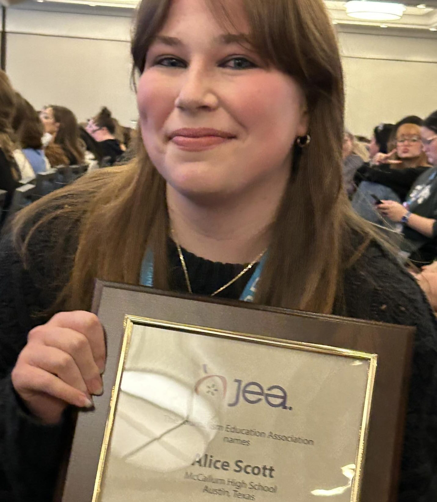 JOY TO THE NATION: Senior Alice Scott, 2022-2024 Shield co-editor in chief, poses with her 2024 JEA Journalist of the Year award plaque she had just received at the NSPA/JEA Spring National Journalism Convention NSPA Awards Ceremony in the Sheraton Kansas City Hotel at Crown Center Grand Ballroom.