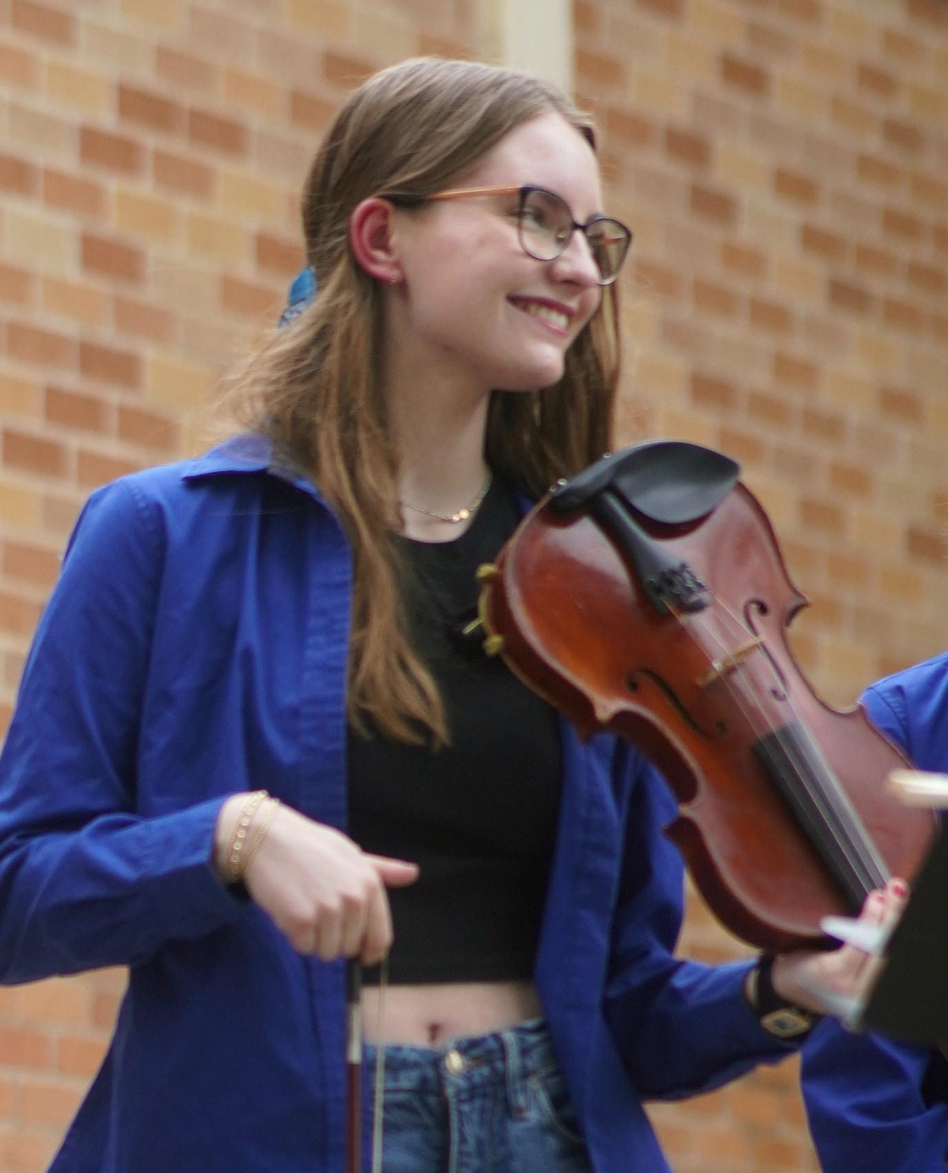 Senior Ingrid Smith, the founder and leader of the Fiddle Club, took center stage with her club colleagues during a lunch time performance in the fine arts courtyard on Fine Arts Week Wednesday on April 24.