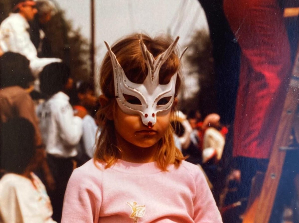 Natalie Seeboth, 5, stands in her Mardi Gras mask and costume, prepared with a plastic bag to hold all the throws that she catches. Photo courtesy of Seeboth.