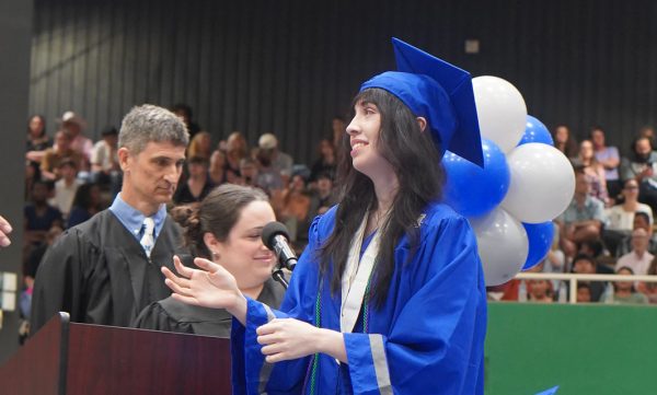Keller walks toward Principal Baxa and her diploma after he name is announced at the Mac commencement ceremony at the Burger Activity Center on May 30.