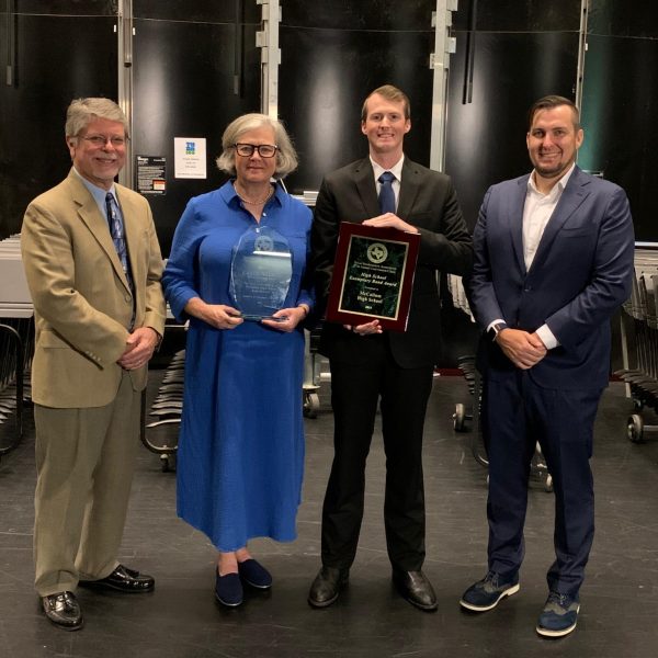 Band directors Jeffrey Rudy, Carol Nelson, Dillon Junkin and Ryan Pride pose with the fruits of their consistent labor: the 2024 Texas Bandmasters Association Exemplary High School Band Program Award. Photo courtesy of Carol Nelson.