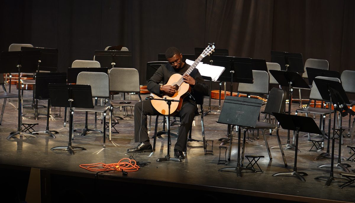 Senior Sebastian Banks performs a solo and his final chamber guitar concert on May 16 in the MAC. "l’d like to join some kind of music group [at St. Ed’s] because I think that’d be really fun," Banks said of his plans to play guitar while in college. "They don’t have classical guitar specifically, which is what I play, but I’ll just have to see." 