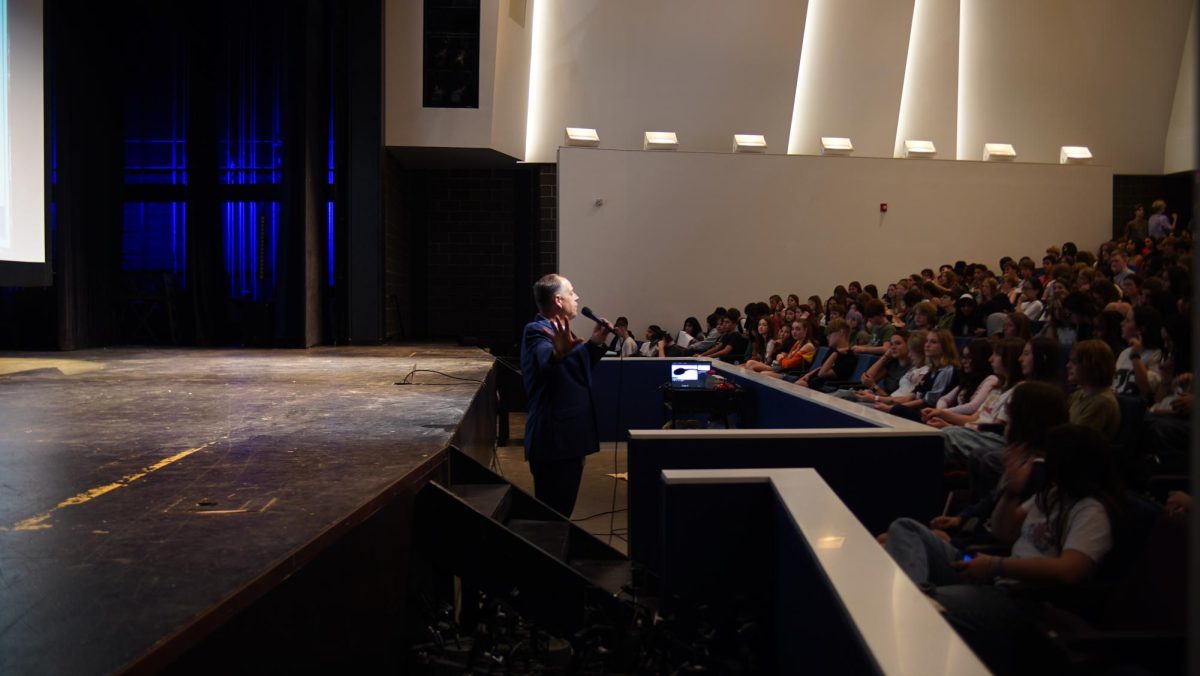 EDUCATING FRESHMEN: Principal Andy Baxa gives a speech at freshman orientation in the MAC this morning to welcome the class of ‘28. Baxa came up with the idea for a Freshman Orientation last year after discovering that some freshmen didn’t understand the nuances of McCallum’s  culture. ”Freshman Orientation accomplished what I wanted to accomplish: introduce the kids to McCallum’s culture and ease them into the transition to high school. We wanted to show them that this is a safe place and that this is a place that celebrates your individuality,” Baxa said. 
Caption by Beatrix Lozach.