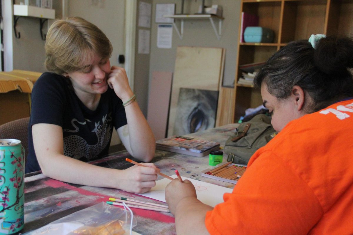 Class of 2024 graduate Julie Kizer and artist Tasha Johnson draw red roses on paper on Aug. 8. Johnson has been with Imagine Art for more than 10 years. The next day, both Kizer and Scout Goldsmith's AmeriCorps terms came to an end.