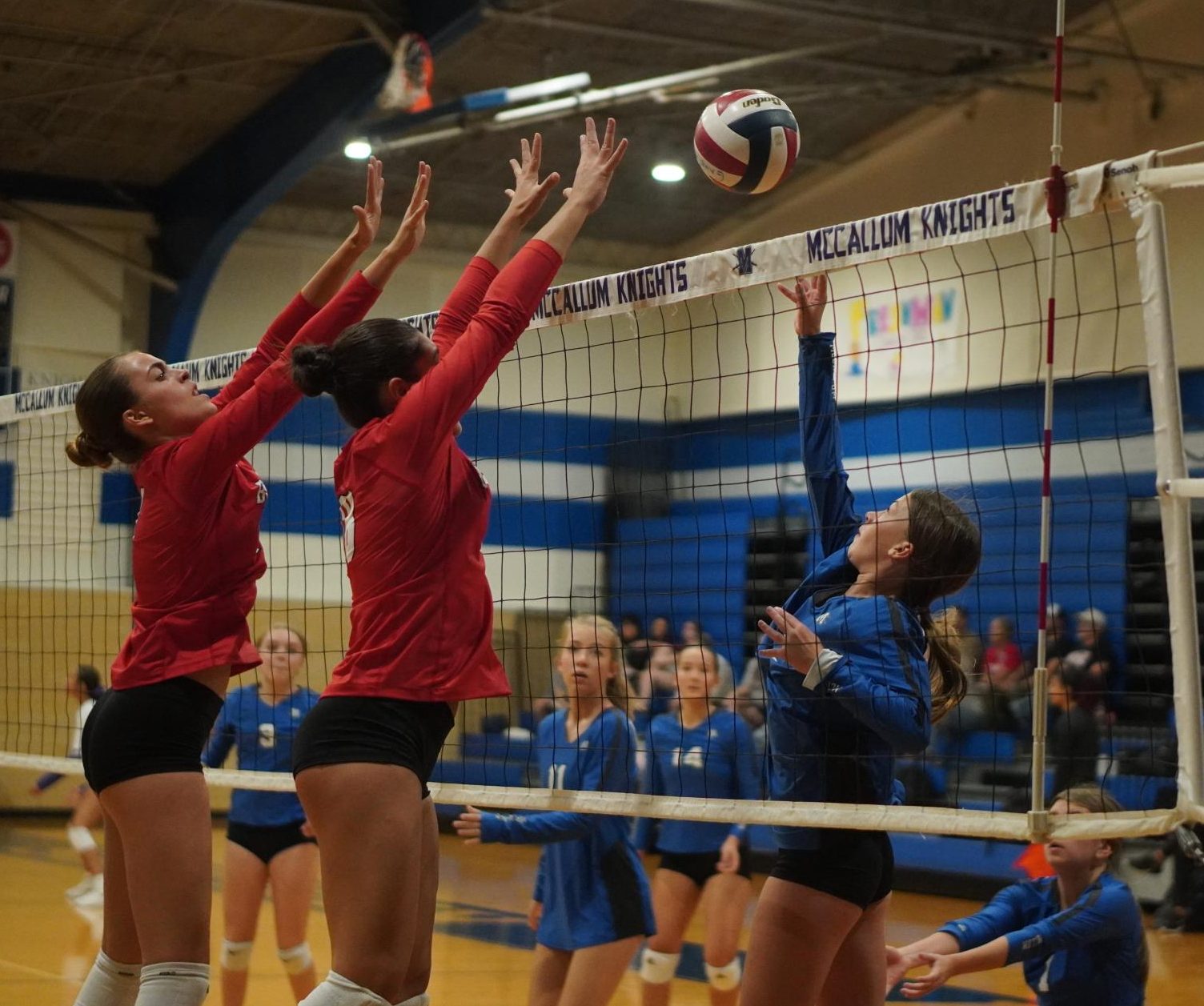 Outside hitter Lucy Tepera lofts the ball over two Bowie blockers during the freshman A team's straight-set loss to the JV Bulldogs in group play of the Knight JV Tournament.