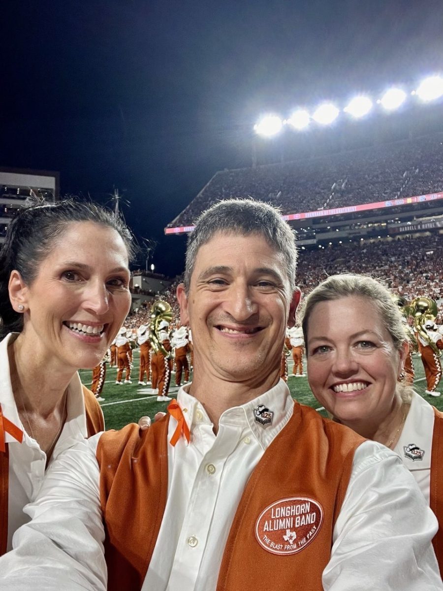 Cowles poses for a selfie with Alumni Band members Kirsten Davenport (left) and Anne Hochfelder (right) before their halftime performance with current members of the Longhorn Band.