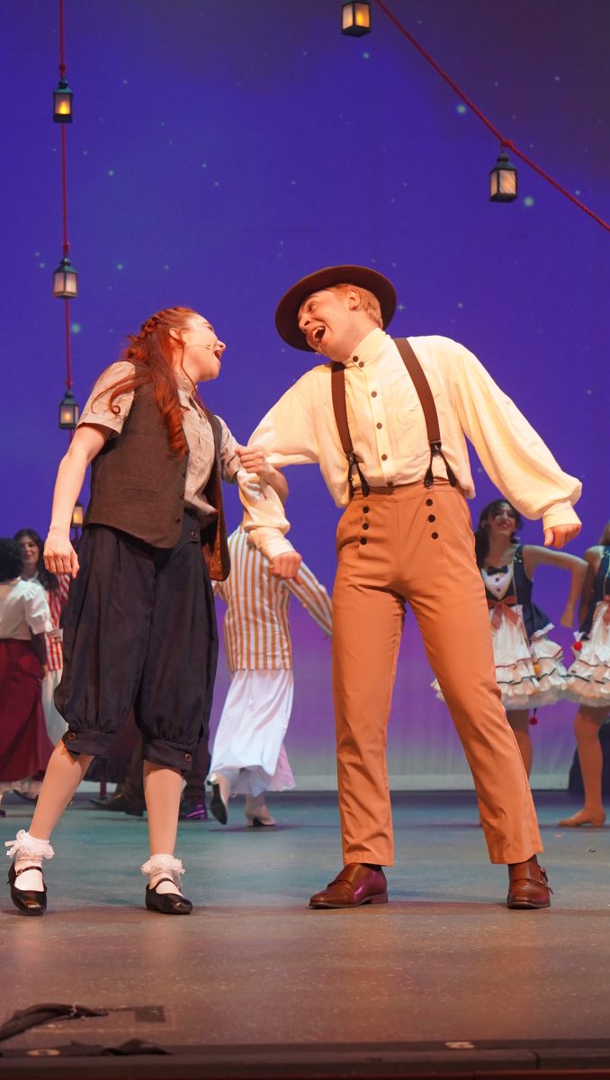 Sophomore Delilah Grad and Senior Austin Pain sing to each other while performing the song, Partner In Crime. 