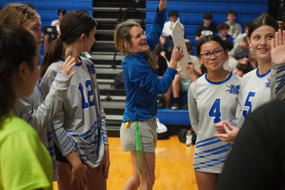 Coach Cat O'Neal recreates middle blocker Harriet Zettner’s back-to-the-net back set, one of the highlights of the San Marcos match that the team celebrated in its post-game huddle.