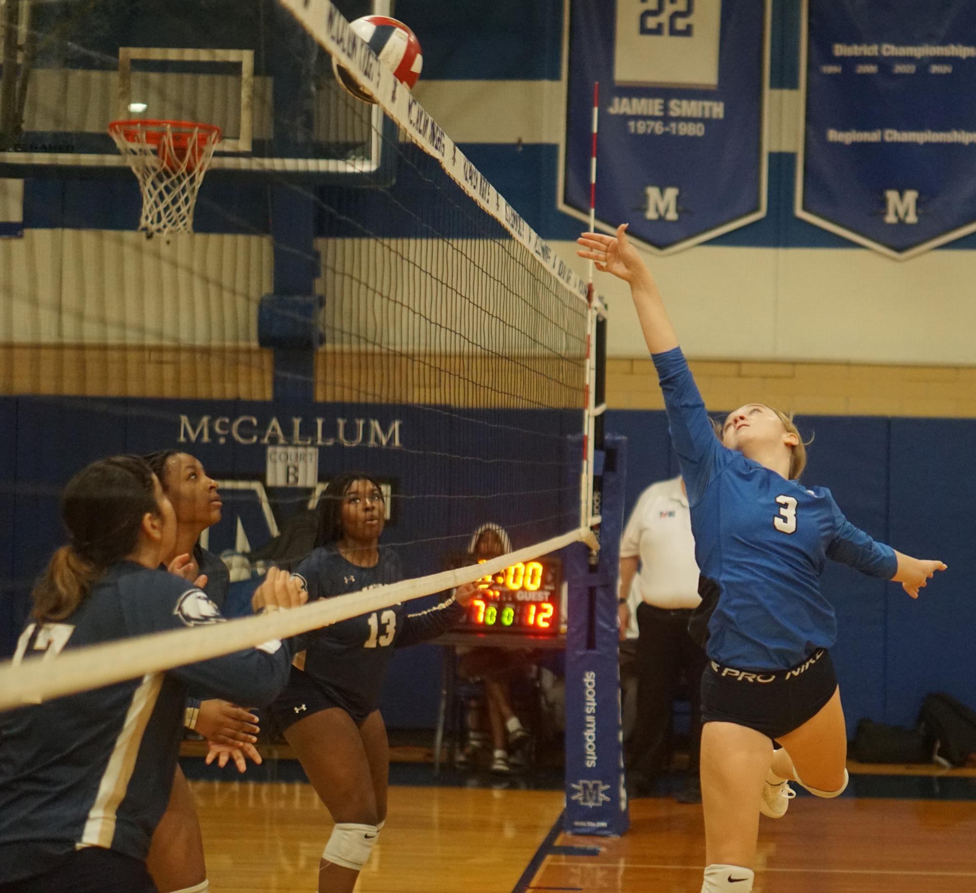 Instead of setting one of her hitters for a kill attempt like she normally would, setter Edie Davidson dinks the ball over the net during the freshman A team's victory over Akins in the silver-bracket semifinals. It was the freshman team's second victory over a JV team from its district during the Knight JV Tournament. 