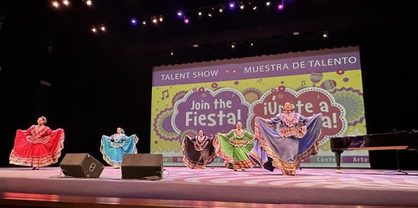 A CELEBRATION OF HISPANIC HERITAGE: Ballet Folklórico dancers Valeria Alcauter Robles (red), Carley Castro-Seiler (turquoise), Abi Peacock (black), Shirel Behar (green) and Mailyn Gil (periwinkle) perform this past weekend at the AISD Performing Arts Center, competing in AISD’s Fiesta for Hispanic Heritage Month. 

Gil has been a part of the club since her freshman year. Upon joining the group she had no idea what it was, but was inclined to join due to influences of her grandfather.

 “I joined because my grandfather loved the traditional dances and that it showcased all regions,” Gil said. “I wanted to honor him in a way, as well as learn more about my culture.”

Competing in a small group ensemble during the Fiesta, Gil felt that the members as well as herself were very composed and performed their routine smoothly. 

“We were very comfortable in our pieces, enough to just get on stage and do what we did, and have fun,” Gil said. “The only difference between this performance and the past was that we had judges this time, so it was a little nerve wrecking since it was a competition.” 

Groups from different schools competed in a variety of categories, some being soloists, music groups, and bands. The groups each performed their pieces, and then the judges took 15 minutes at the end to go over scoring before they announced the winners.

Gil said that even though the club did not win, they felt proud of their performance. 

“We were very positive and respectful, and even though we didn’t win we felt proud of our accomplishments,” Gil said. “I was proud of our newcomers because they learned everything so quickly and got the hang of it.” 

Caption by Priya Thoppil.