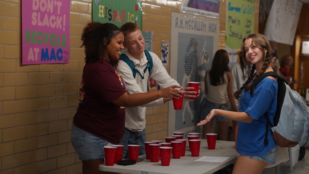 SHARING IS CARING: Senior Trinity Ritcherson and junior Ronan Henson hand senior Sonya Petersen a cup of Jarritos soda last Tuesday for McCallum’s Hispanic Heritage Month celebration. Tuesday marked the end of Hispanic Heritage Month, which began on Sept. 15. Ritcherson is the vice president of the Students of Color Alliance and was helping to run activities during Hispanic Heritage Month. 

“It’s a safe space where students of all cultural backgrounds can connect and become educated on their differences and their similarities,” Ritcherson said. “We try to regularly fundraise for the club while also advocating for cultures outside our own.”

Ritcherson explained that the Students of Color Alliance is not only a place for students to connect but also one for learning and education.

“We celebrate diversity that is seen throughout McCallum while trying to educate students on cultural literacy,” Richardson said. 

As Hispanic Heritage Month comes to a close, the Students of Color Alliance will begin working on plans for Native American Heritage Month in November. 

“We want to send out a reminder to others that cultures outside our own are still important and should be recognized,” Ritcherson said. 

Caption by Evelyn Jenkins.