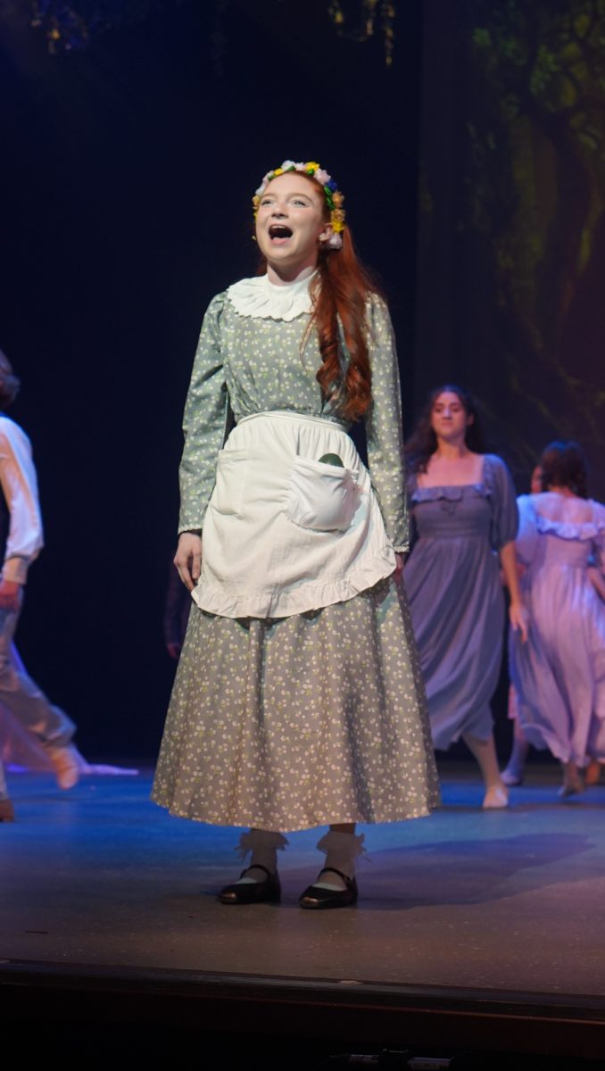 Sophomore Delilah Grad performs as Winnie Foster in the song, "Live Like This" at the opening of Tuck Everlasting. Grad said that she felt especially nervous during this number, because during this song is the first time Winnie is seen by the audience.
"I was really, really nervous at the beginning of the show, so I felt a little shaky throughout the opening number," Grad said. "This was also our first run using the mechanical toad, so I messed up most of the toad blocking."