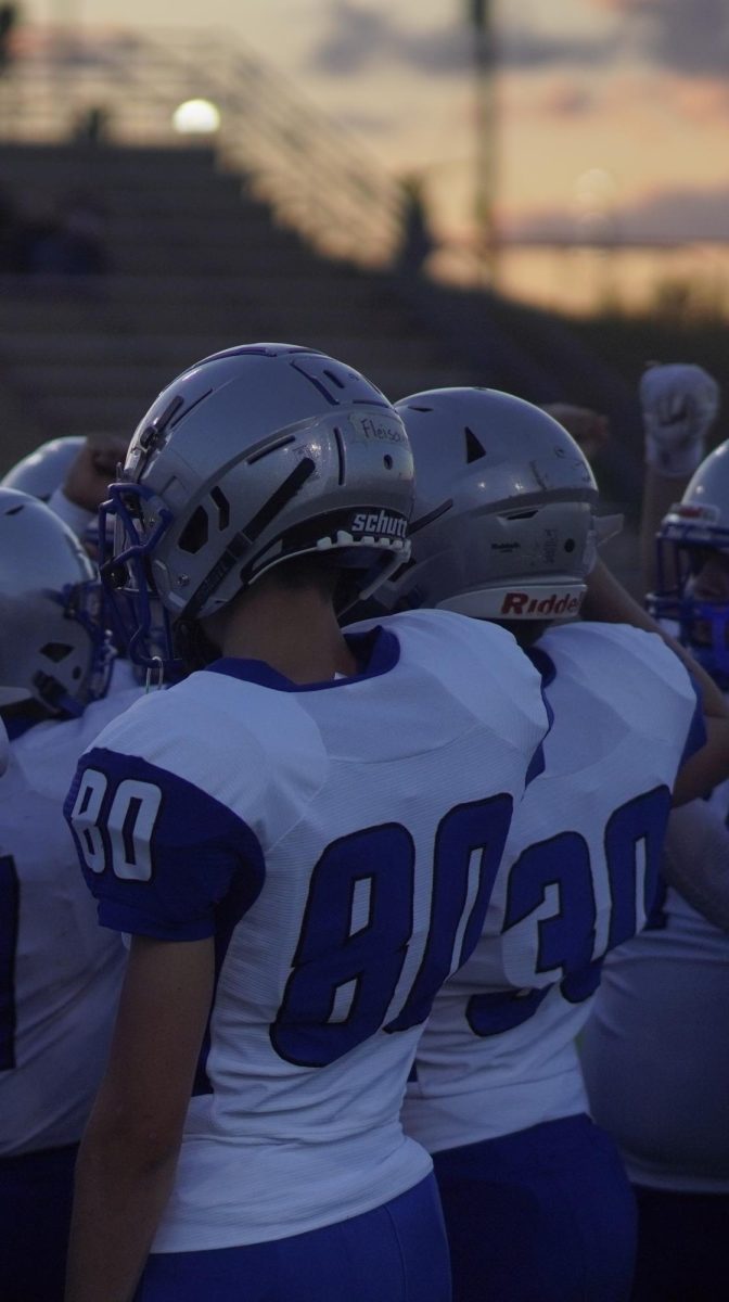 Fleischer (No. 80) huddles up with his teammates as they took on Pflugerville at Pflugerville High School on Oct. 12. 