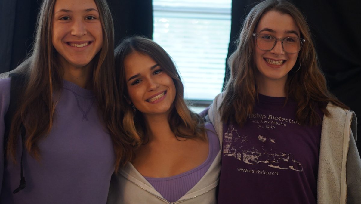 DRIPPED OUT IN PURPLE: Sophomores Hazel DeMont, Nytle Herron and Isla Brown pose for a photo together on Thursday, Oct. 17 for the colors wars,   spirit day—freshmen dressed in green, sophomores in purple, juniors in red, and seniors in blue. 

DeMont  thought the spirit day was fun because it was one of the only days during the homecoming spirit days that she could partake in considering she had purple items.

“Usually I don’t get dressed up, but some of my friends were, and it’s fun to match,” DeMont said.

DeMont acknowledges that a reason why she doesn’t dress up sometimes is due to her lack of spirited clothes. 

“I also don’t participate when I don’t have the right clothes, but that day I did,” DeMont said. “I honestly don’t know how people find out what to wear during spirit weeks.”

DeMont wasn’t sure what the spirit day was for Thursday until she overheard her friends from other grades talking about which colors they were going to wear. 

“I was excited when I heard that I was purple because I had a few purple clothes,” DeMont said. 

Whenever spirit days happen, DeMont is always excited to see what people are wearing. 

“People’s outfits are always so fun and festive,” DeMont said. “It’s meant to show support and bring community together.”

Caption by Maya Tackett. 
