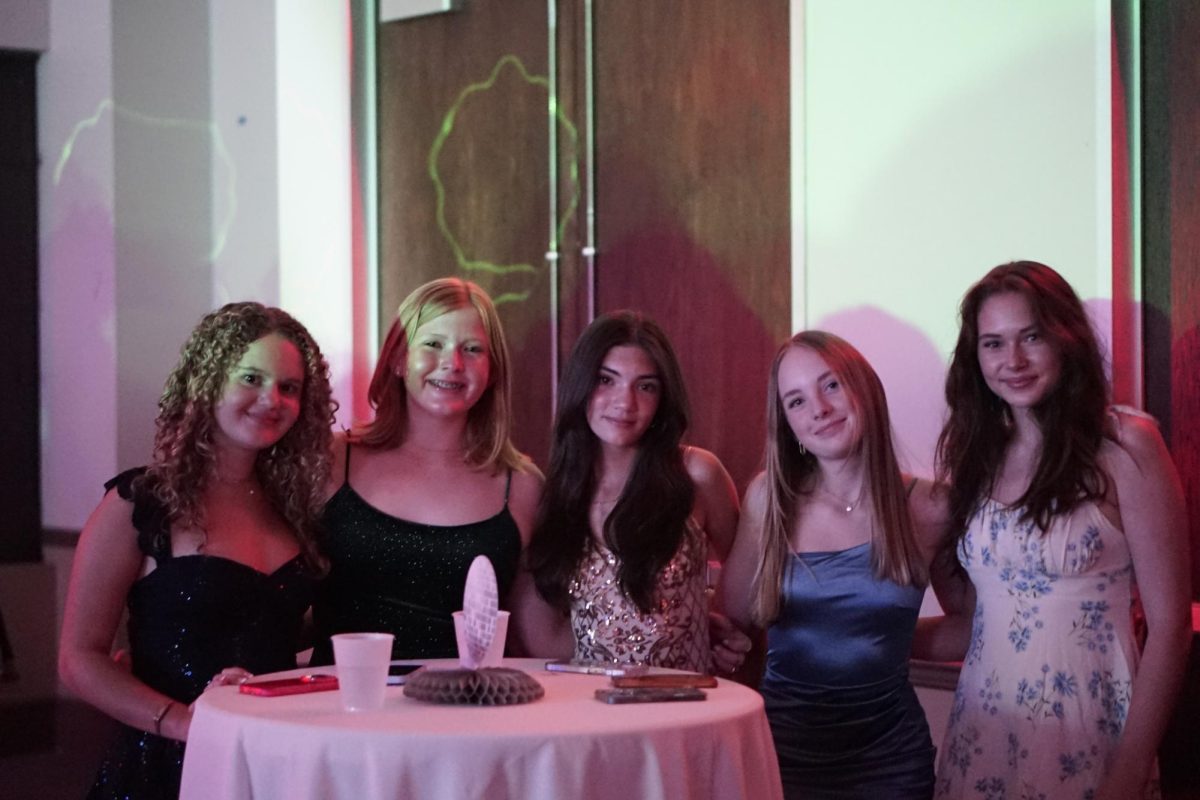 SNAP A PHOTO: Students of all grades attend the homecoming dance at the Red Oak Ballroom last Saturday. From freshmen to seniors, all students were able to hang out and have the opportunity to have fun together. 

Around the dance, there were multiple places to hang out with your friends and enjoy their company. Freshman Layne Long (far left) specifically enjoyed the photo booth. 

“The photo booth was cool and there was a cool system where you could take cute photos with your friends,” Long said.

Throughout the ballroom, music was able to be heard. Students danced on a central floor and tunes pulsated throughout. 

“The music was really good too, I liked the DJ a lot,” Long said.

Caption by Arwen Pelletier.